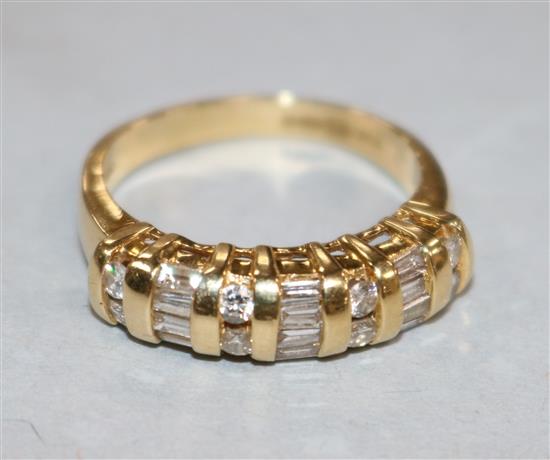 A modern 18ct gold, round and baguette cut diamond set half hoop ring, size M.